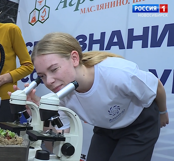 Девушка смотрит в микроскоп